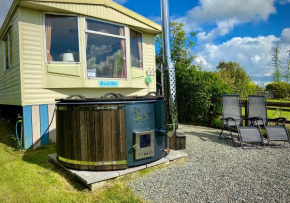 The Beach Hut, sleeps up to 4 guests and has a Private Hot Tub, FirePit, BBQ and is located in a Peaceful setting with Alpacas and gorgeous countryside views on Anglesey, North Wales